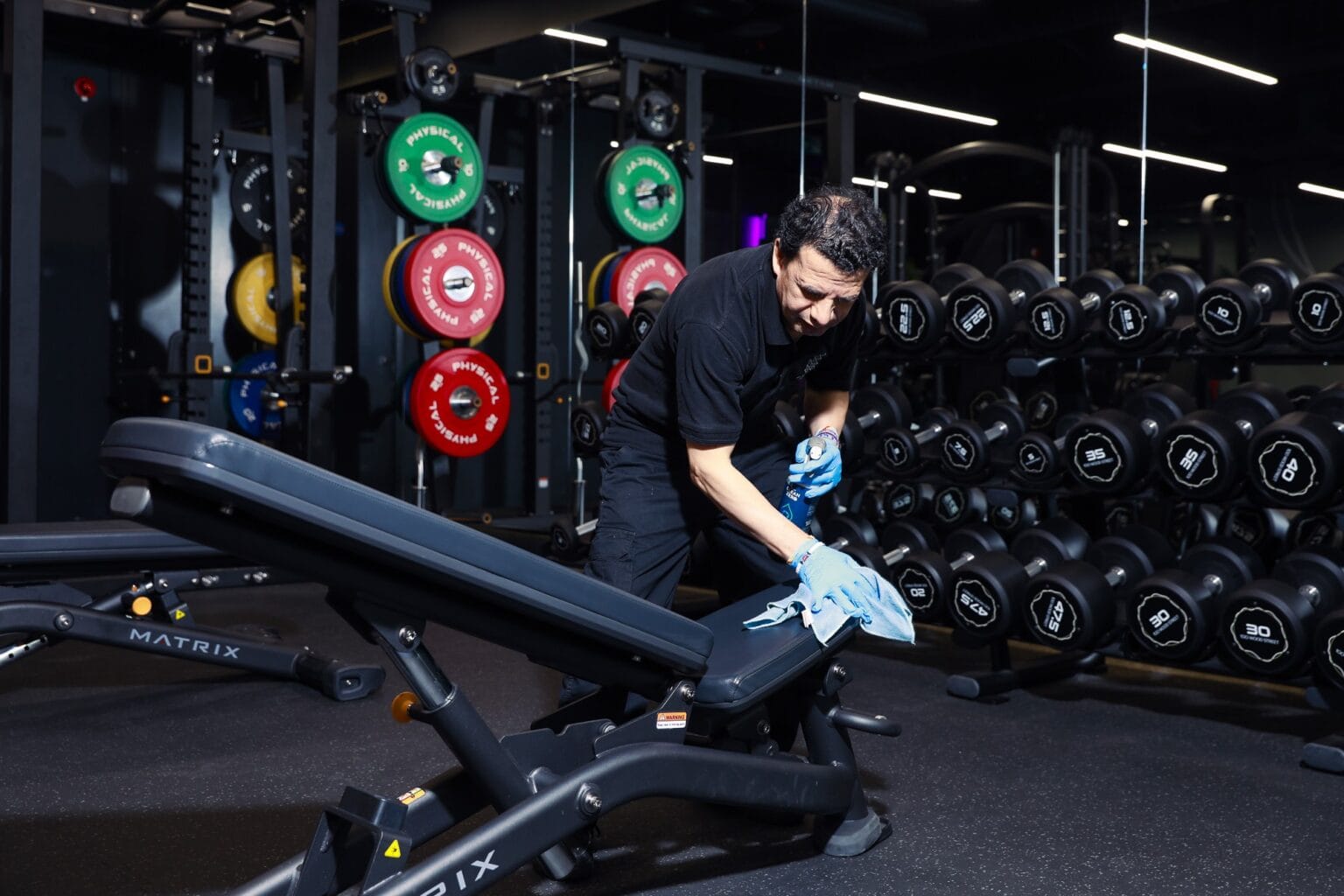 JPC by Samsic cleaner wiping down gym equipment
