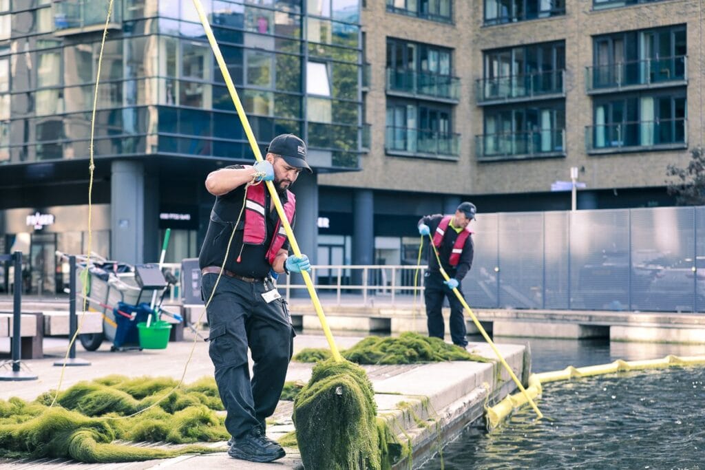 JPC by Samsic team cleaning around an outdoor water feature