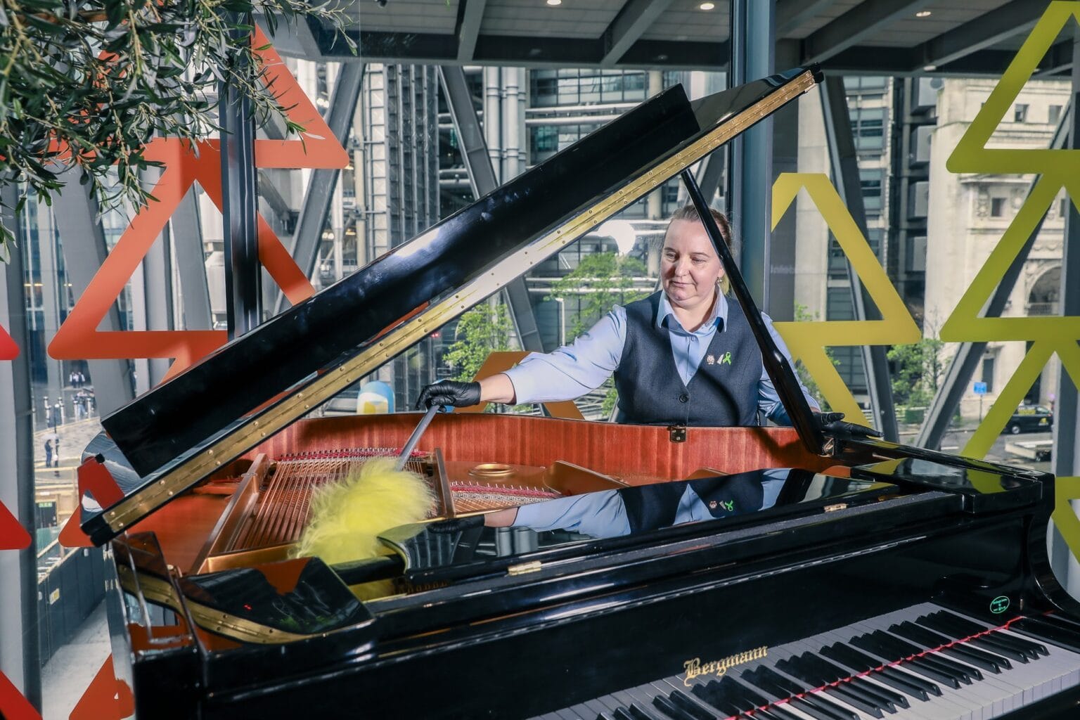 JPC by Samsic team member dusting a grand piano