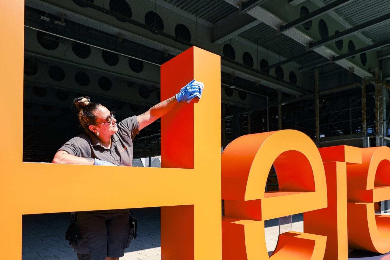 JPC by Samsic cleaner cleaning signage at a London technology campus